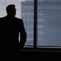 Businessman, silhouette, windows — Futures Trading Review Offers Insights into Real Trader Experiences